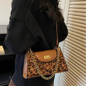 Fashionable leopard print baguette bag with gold chain strap and metallic twist lock