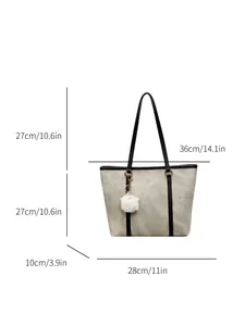 Minimalist grey marble tote bag with black straps and plush ball charm in a front view
