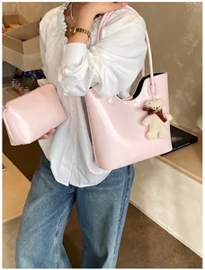 Detail of soft pink glossy tote bag set with matching small pouch and plush bear charm