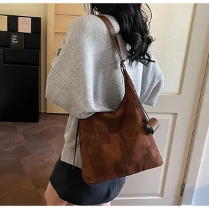 Macro detail of brown textured jacquard tote bag with stylish geometric pattern