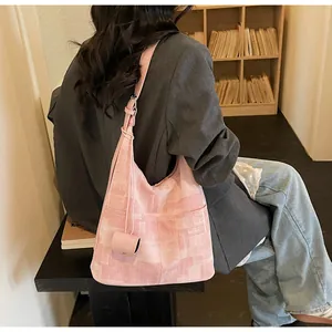 Detailed texture of pink patterned canvas tote bag with matching mini pouch charm