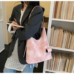 Pink canvas tote bag with abstract patterns and matching small accessory pouch