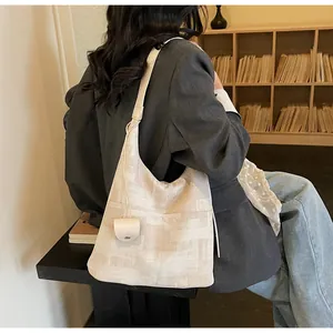 Large cream canvas tote bag with brown geometric patterns shown in a warm indoor setting