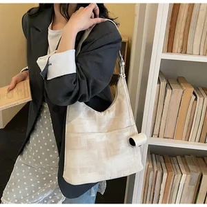 Artistic textured canvas tote bag with unique paint print shown in a library setting