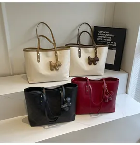 Detail view of four textured tote bags with chic dog charms and checkered patterns