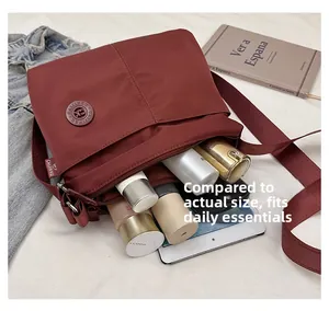 Detailed view of spacious burgundy nylon tote bag showing interior storage capacity