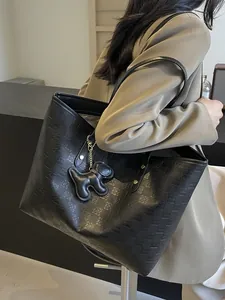 Large black tote bag with embossed checkered pattern and dog charm for women