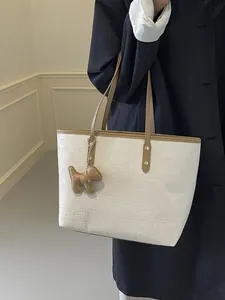 White embossed checkerboard tote bag with brown trim and cute dog charm for women