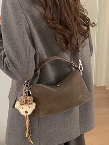 Borsa baguette marrone scamosciata con ciondolo a forma di orso e tracolla regolabile