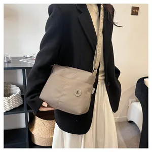 Detail showing high-quality waterproof nylon texture and adjustable branded strap of the tote