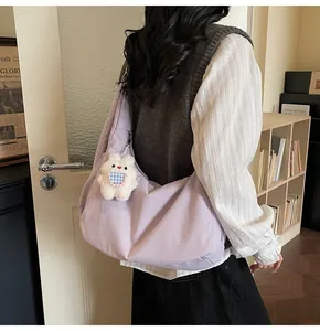 Detailed back view of a light purple quilted tote bag with a cute white rabbit charm