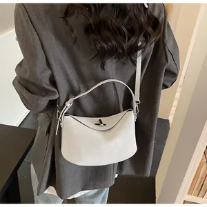 Detail of grey saddle bag featuring silver twist lock and dual strap configuration