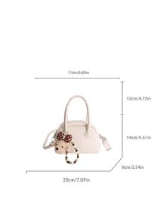 Minimalist beige baguette bag with plush bear charm and crossbody strap dimensions