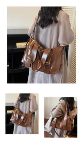 Dettaglio macro della borsa tote in pelle vintage marrone con fibbie in metallo bronzo