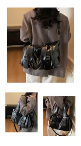 Dettaglio della pelle sintetica vintage e fibbie in bronzo sulla grande borsa shopper nera
