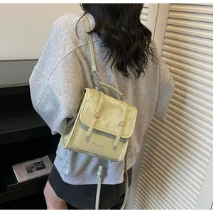 Detail of light green multi-functional mini backpack worn as a stylish crossbody bag