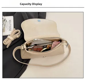 Internal view of cream bow crossbody bag showing capacity for phone and cosmetics