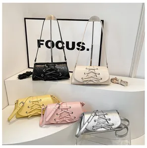 Multiple colors of pleated corset-style baguette bags displayed on a sleek tiered stand
