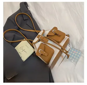 Detail of canvas and brown leather patchwork backpack with vintage buckle closures