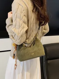 Dark green suede crescent hobo bag with bohemian wooden bead and yellow pom-pom charm