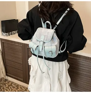 Detail view of mini tweed backpack in blue and white with silver metal buckles on a model