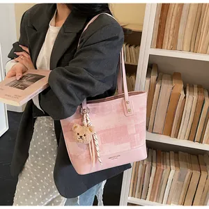 Pink contrast color tote bag with checkered fabric texture and cute plush bear charm