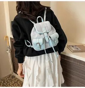 Detail of a casual blue and off-white small backpack with multiple buckle pockets