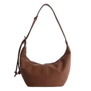 Minimalist dark brown hobo shoulder bag in pebble leather with knotted strap detail