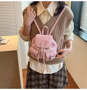 Detailed close-up of pink tweed mini backpack showing texture and leather buckle detail