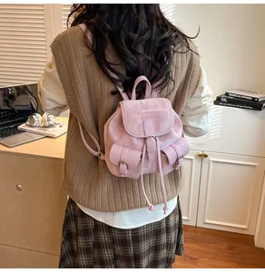 Detail of pink canvas and leather mini backpack with textured fabric and buckle side pockets