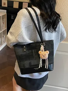 Women's chic grey jacquard tote bag with black leather base and plush bear charm