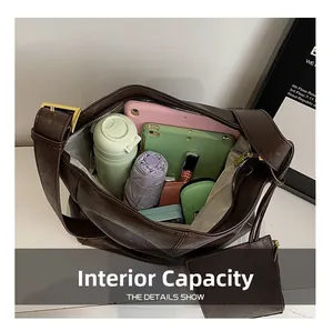 Internal capacity of large dark brown tote bag showing tablet, water bottle and cosmetics