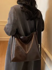 Deep brown large capacity tote bag with glossy finish and wide shoulder strap