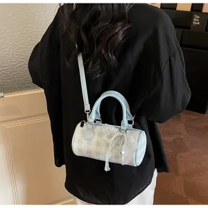 Blue and white checkered bowling bag with pearl bow details shown in a lifestyle setting