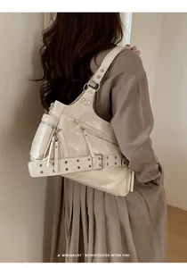 Detail of vintage cream motorcycle tote bag with pleated leather and metal eyelet straps