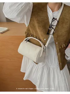 Detailansicht der beigefarbenen Boston Bag mit verstellbarem Gurt und glatter Lederstruktur