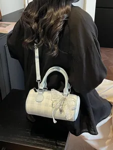 Light blue checkered bowling handbag with a large lace pearl bow and crossbody strap