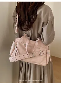 Retro light pink tote bag styled on model shoulder showing size and vintage vibe
