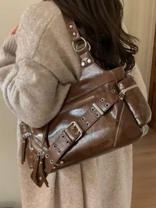 Retro dark brown oily leather tote bag with metallic stud details and multiple zippers