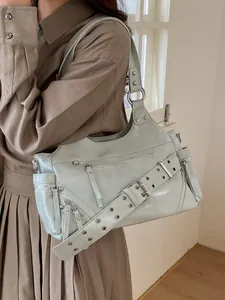 Chic light blue multi-zipper tote bag with silver rivets and wide adjustable strap