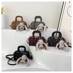 Detailed set of five vintage textured mini boston bags with cute plush rabbit charms