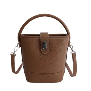 Minimalist dark brown litchi pattern leather bucket bag with silver twist lock and strap