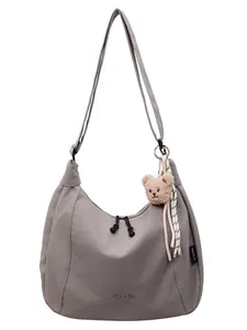 Large grey canvas crescent crossbody bag with cute teddy bear keychain for women