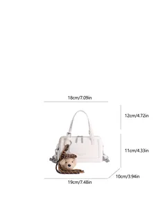 White faux leather baguette bag with silver hardware and teddy bear charm size guide