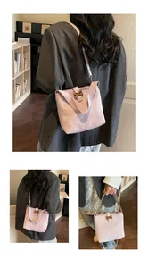 Detail of light purple bucket bag with leopard bow clasp and adjustable shoulder strap