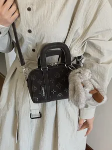 Brown frosted leather baguette bag with floral embossing and plush rabbit charm