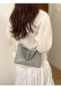 Vue détaillée du sac porté épaule minimaliste vert sauge avec boucle sur un mannequin