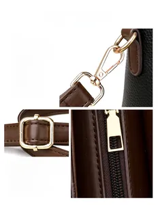 Detailed view of polished gold hardware, lobster clasp, and buckle on pebble grain leather