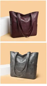 Detail of soft leather tote bags in burgundy and metallic gray with spacious pockets