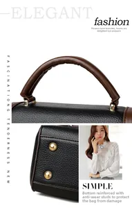 Detail of protective gold metal feet on black litchi pattern leather handbag base